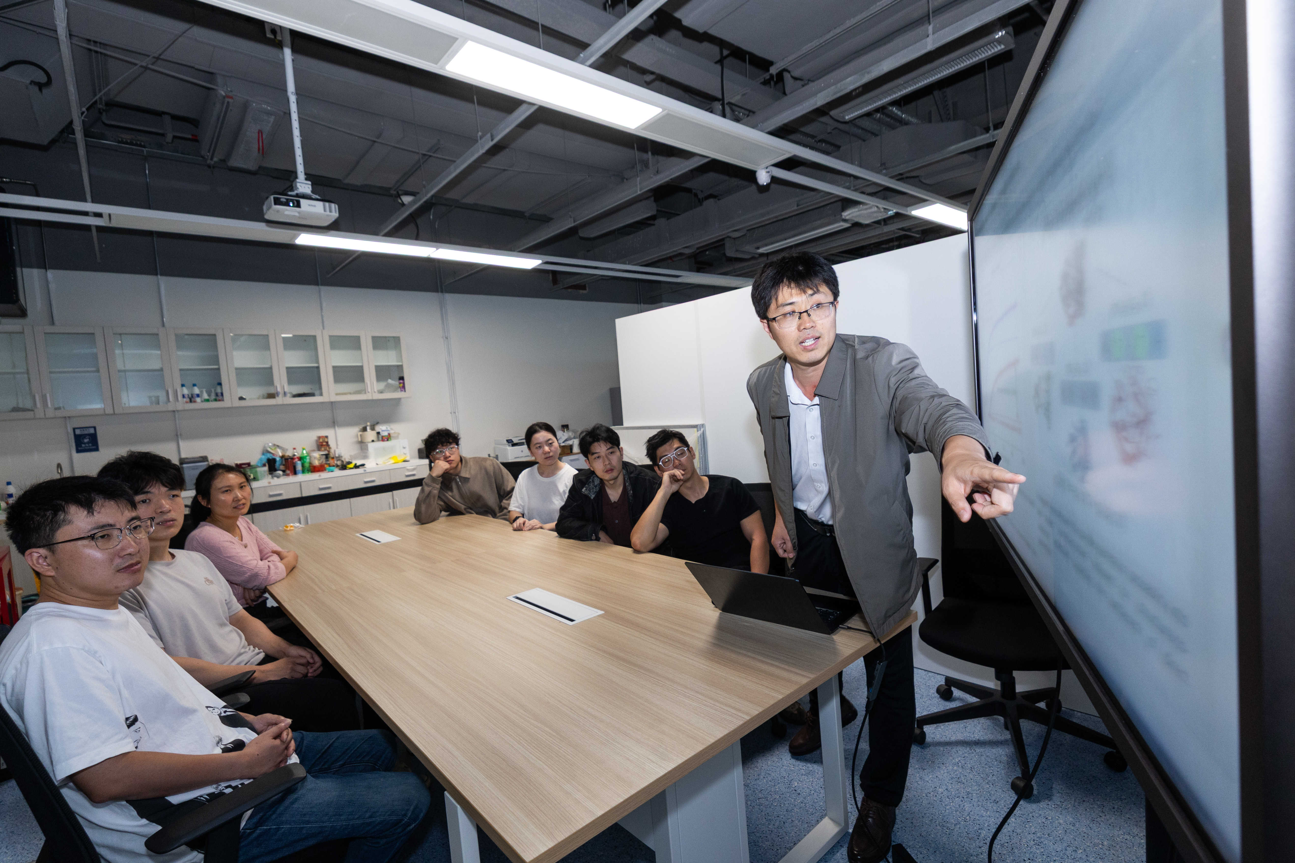 The research team discusses protein design
